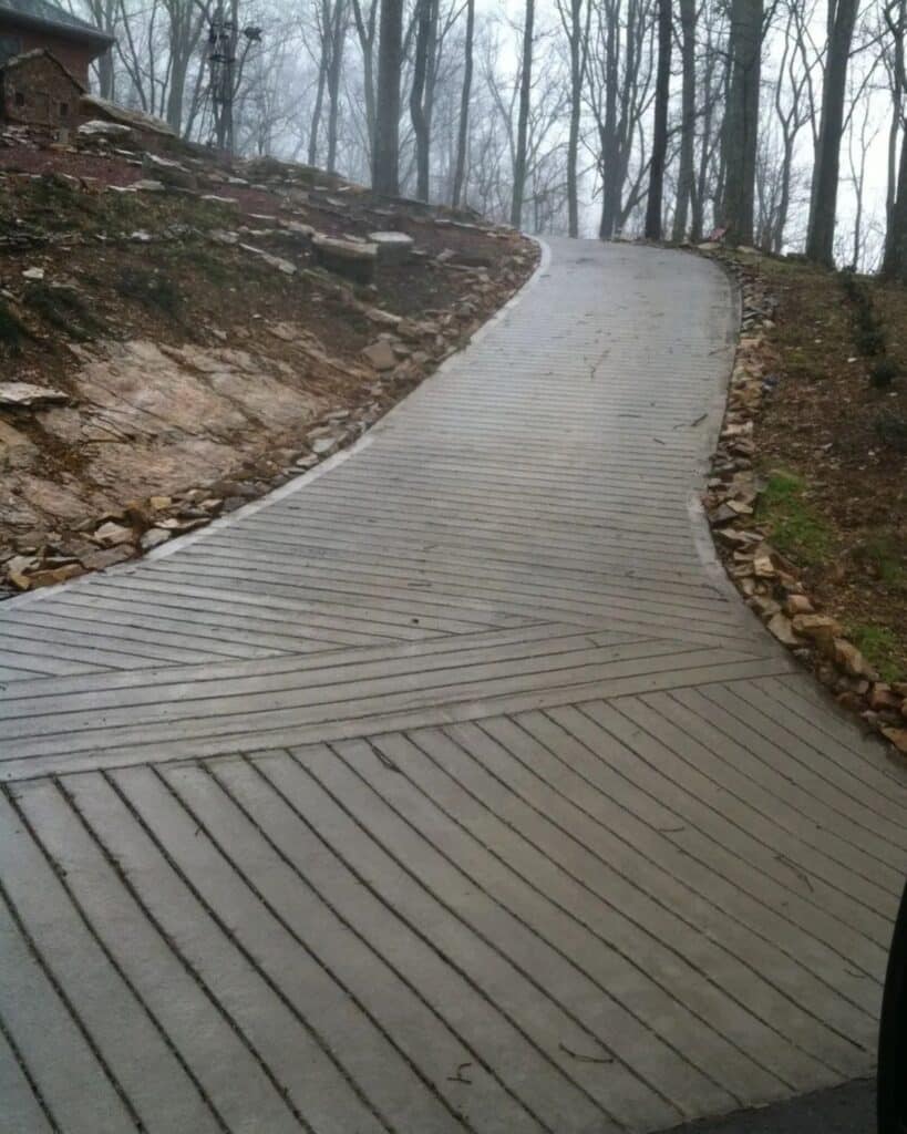 Traction-grooved concrete driveway with picture-frame edging on a steep hill in Tennessee.