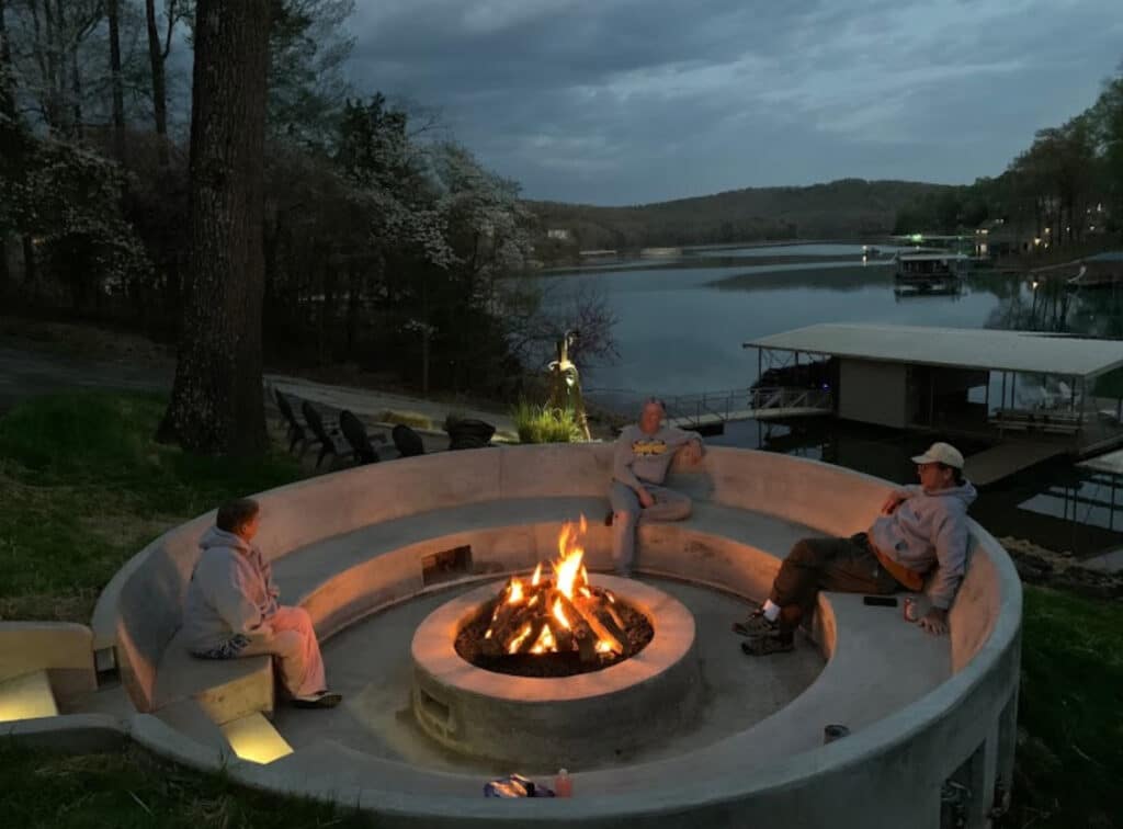 custom concrete fire pit seating area with people enjoying the fire in Knoxville TN