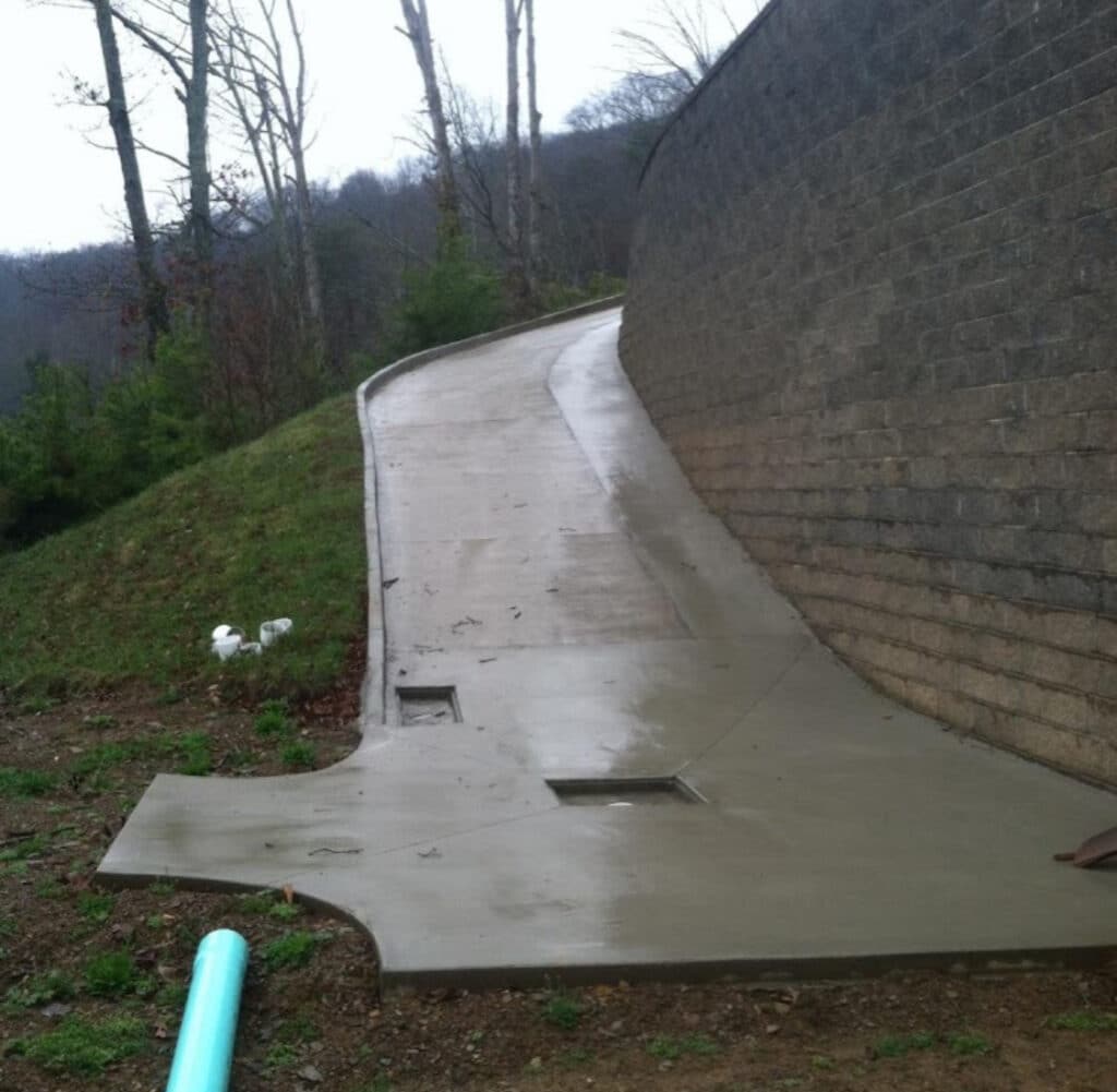 Concrete driveway with integrated curb, flume, and drain system installed by Crescostone concrete contractor Knoxville