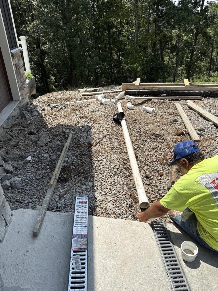 Crescostone repairing bad concrete work with drain system installation after a previous contractor caused water to flow toward the house